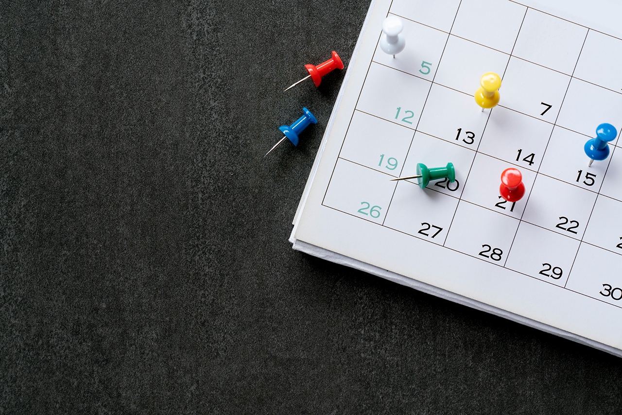 close-up-of-pin-on-calendar-planning-for-business-meeting-or-travel-planning-concept